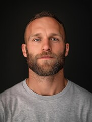 Fototapeta premium Close-up portrait of a man's face. he is looking directly at the camera with a serious expression. he has short, light-colored hair and a beard.