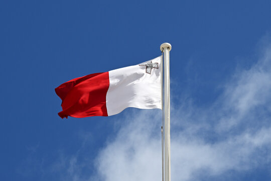 Malta national flag against blue sky