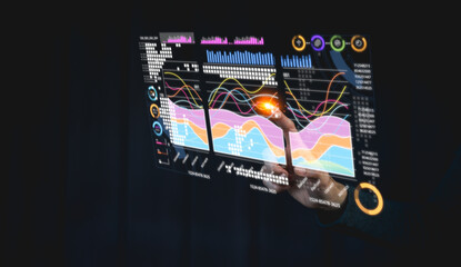 A futuristic interface displaying data visualizations, including graphs and charts, with a hand interacting with the digital elements.