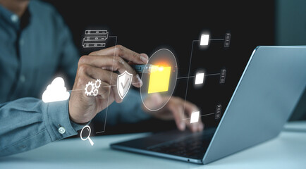 A businessman using a laptop, interacting with digital icons and data visualization elements, representing technology and innovation.