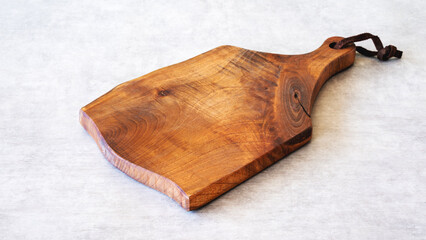 Wooden cutting board on background