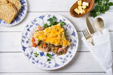 Shepherd's Pie or Cottage Pie on white wooden background. Traditional Irish and British dish. High angle view