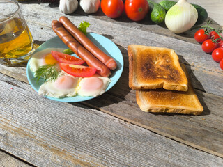 English breakfast with scrambled eggs, potatoes, sausages. High-quality photos