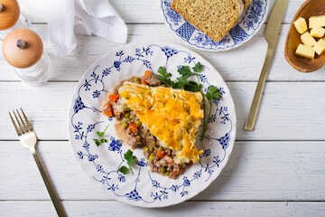 Shepherd's Pie or Cottage Pie on white wooden background. Traditional Irish and British dish. High angle view