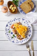 Shepherd's Pie or Cottage Pie on white wooden background. Traditional Irish and British dish. High angle view