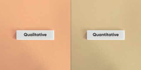 Qualitative versus Quantitative Banner. Text on Block Letter Tiles on Yellow and Blue Background....