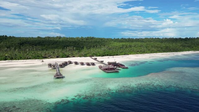 Maratua, Indonesia: Aerial drone footage of overwater bungalow in the idyllic Maratua island in the Derawan archipelago in Kalimantan in Indonesian Borneo. 