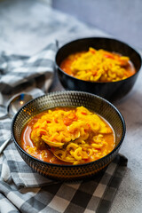 homemade fish and clam noodle casserole recipe in a black bowl