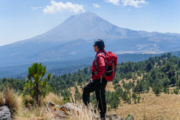 Hiker contemplating popocatepetl volcano in mexico