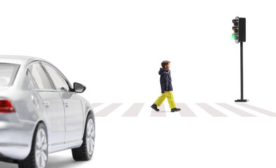 Full length profile shot of a boy in winter clothes crossing a street at traffic lights