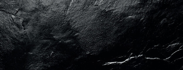 Dark black background with a textured, rough surface. The black background adds a dramatic, moody effect with subtle variations in texture. Textured stone background vector. Black background.