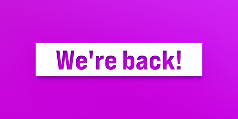 We're back! Die-cut letters on a purple background. Motivation, reopening, new beginnings, greeting, teamwork, opening event.