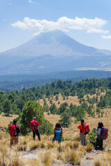 Hikers admiring popocatepetl volcano in mexico