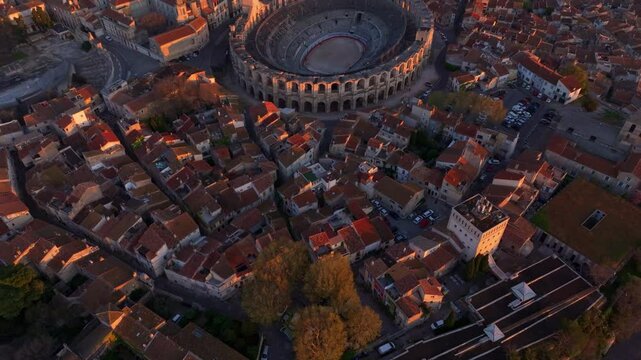 Aerial glimpse of old Arles kissed by sunrise warmth. Aerial drone video