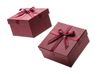 Obraz premium Two elegant red gift boxes with satin ribbons create festive atmosphere. Perfect for special occasions and celebrations