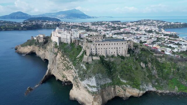 Flying towards Terra Murata hill (with abandoned ruins of Palazzo d'Avalos and abbey of San Michele Arcangelo) Procida, scenic landscape and tourist destination Italy
