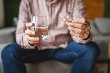 senior man take drug tablet drink painkillers, health care concept