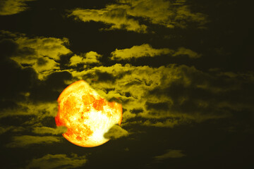 Super Full hunger blood moon on the night sky back dark yellow cloud