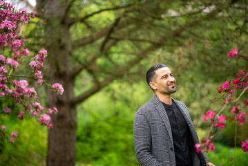Young hispanic male enjoying nature in blooming park setting
