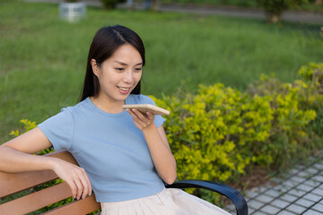 Fototapeta premium Woman using voice command on mobile phone