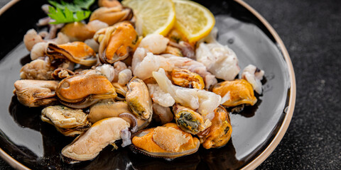 Seafood mix frut de mer mussels, shrimp, prawn, rapan, squid dish fresh gourmet food background on the table rustic food top view copy space keto  paleo diet vegetarian pescetarian diet