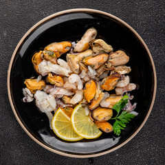 Seafood mix frut de mer mussels, shrimp, prawn, rapan, squid dish fresh gourmet food background on...