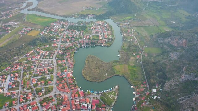 Boats sailing along the meanders of the Dalyan River, lush reeds and the surrounding natural beauty reflect the peaceful atmosphere of this picturesque region.