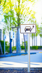e-car charge point or electric car, vehicle charging station EVSE with information sign electric...