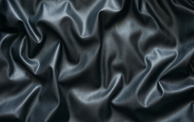 Surface features rich black eco-leather texture, highlighting deep folds and subtle reflections. This close-up reveals unique qualities of material, emphasizing its luxury and depth.