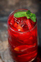 glass of refreshing cold fruit tea with mint, closeup