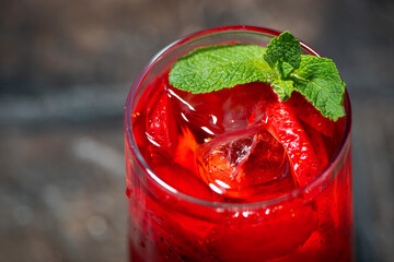 glass of refreshing cold fruit tea with mint