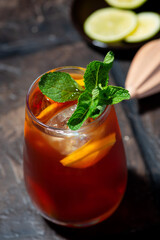 glass of iced tea with lemon and fresh mint, vertical