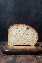half of white bread on a wooden cutting board