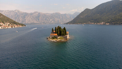 Aerial view of St. George Island surrounded by sea. Tourist attraction of the ancient monastery on the island near Perast, in the Bay of Kotor, Montenegro