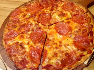 Delicious pizza with ham, mozzarella  served on wooden table