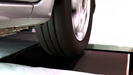 Close-up view of car wheel in blur motion during rolling resistant test, measure dynamic...