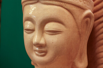 Ancient Chinese stone sculpture. Ancient culture. Stone face carved with oriental features.