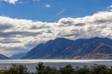 Obraz premium Grassy mountains surround Hawea Lake. South Island, New Zealand