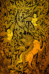 Antique Thai Lacquer Works. Gold Thai Angel figure are made into gauge doors of temple at Wat Khao Yi San, Samut Songkhram, Thailand.Traditional Thai sculpture style.Vertical.