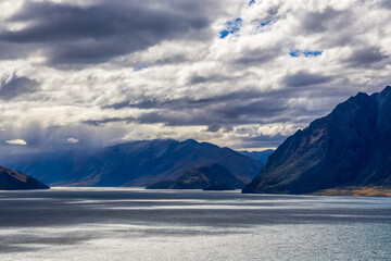 Grassy mountains surround Hawea Lake. South Island, New Zealand