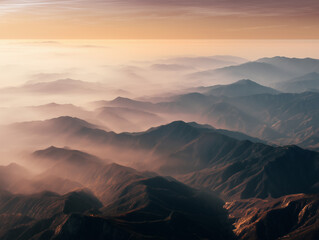 Aerial sunrise view of mountain landscape with mist and layers..
