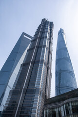 Fototapeta premium Shanghai, China, city buildings. Modern skyscrapers against blue sky, high rise glass office business towers