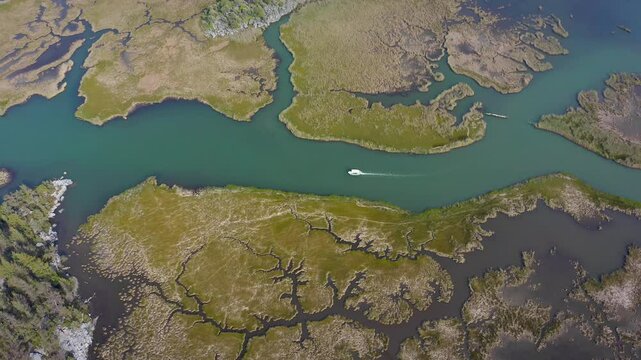 Dalyan is surrounded by reeds and fascinates with its unique nature. The drone that follows the boat takes a quiet journey and the peaceful and protected ecosystem of the region is seen.