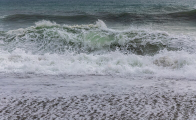 Fototapeta premium Big crashing waves in a stormy ocean. South Island, New Zealand