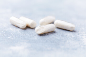 Coenzyme Q10 capsules. Antioxidants. Concept for a healthy dietary supplementation. Bright background. Soft focus. Close up. Copy space.