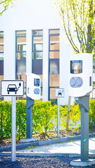 e-car charge point or electric car, vehicle charging station EVSE with information sign electric car public charging point station with free spaces, parking spaces