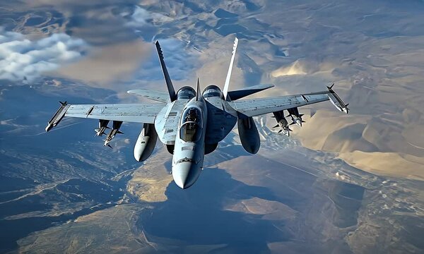 Fighter jet soars above arid land. It flies, carrying missiles. A clear view above, capturing the sky