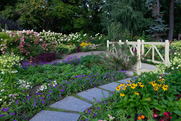 Garden Path with Bridge Surrounded by Flowers