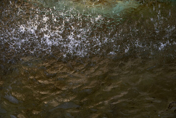 Splashing Water Surface with Droplets Falling