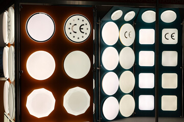 An assortment of single-lamp lamps at the stand of the trading platform. Trade in chandeliers in an electrical store